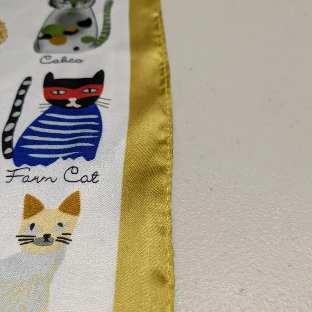 Assorted colorful whimsical cats on white background with gold trim scarf